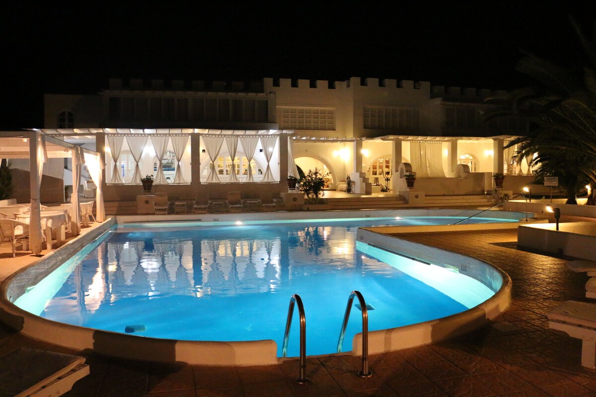 Pool and restaurant illuminated at night